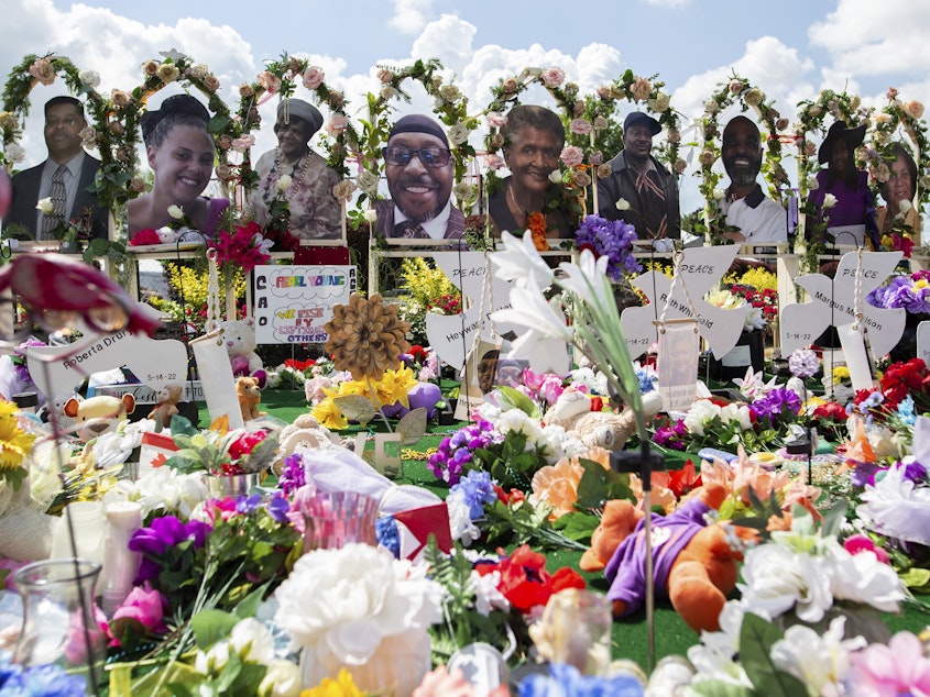 caption: The white gunman who killed 10 Black people and injured three other individuals at a Tops supermarket in Buffalo, N.Y., in May was indicted by a federal grand jury on Thursday on hate crimes and firearm charges. Here, a memorial for the supermarket shooting victims is set up outside Tops on July 14.
