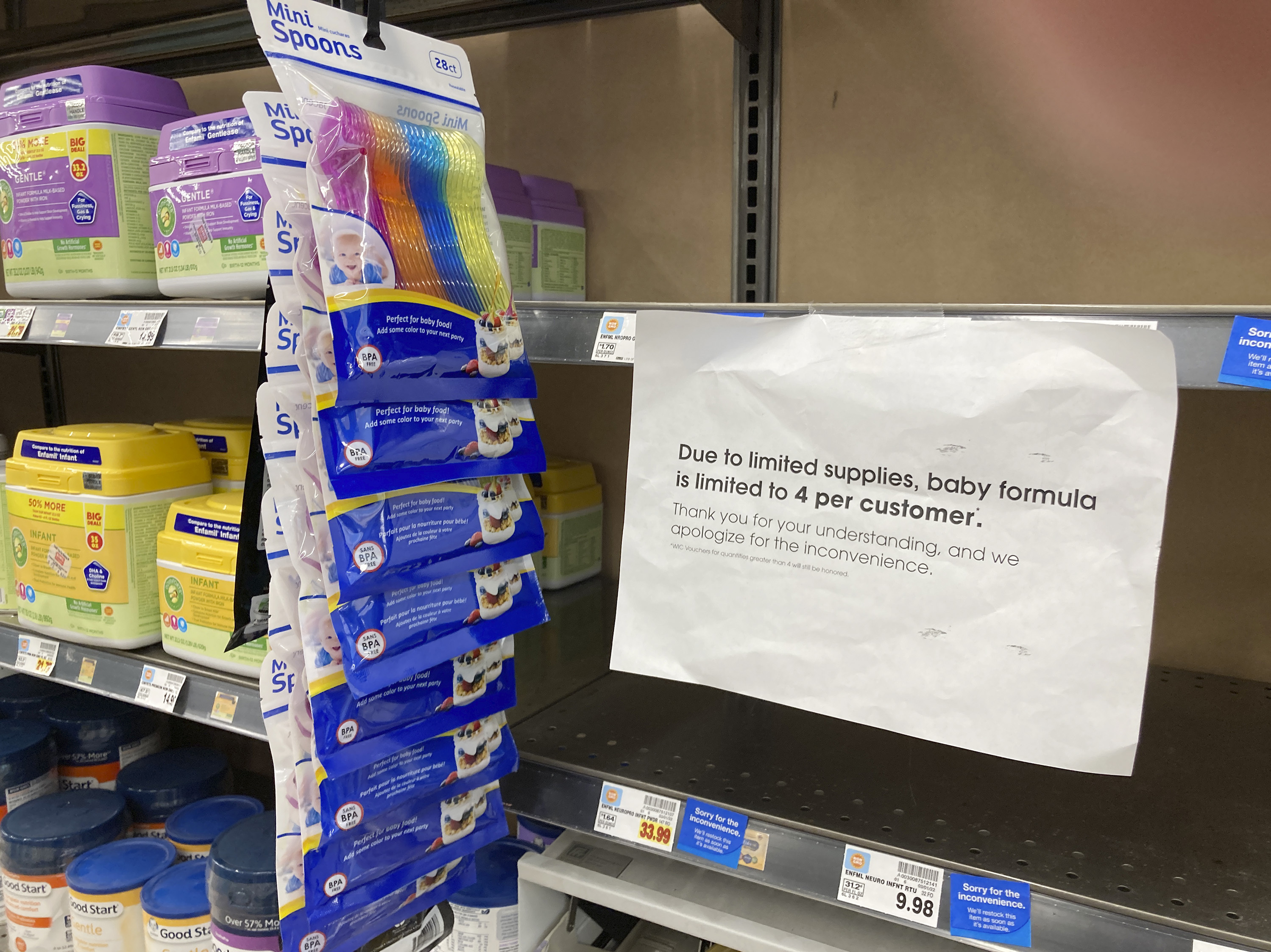 caption: A sign telling consumers of limits on the purchase of baby formula hangs on the edge of an empty shelf for the product in a King Soopers grocery store, Wednesday, in Denver.