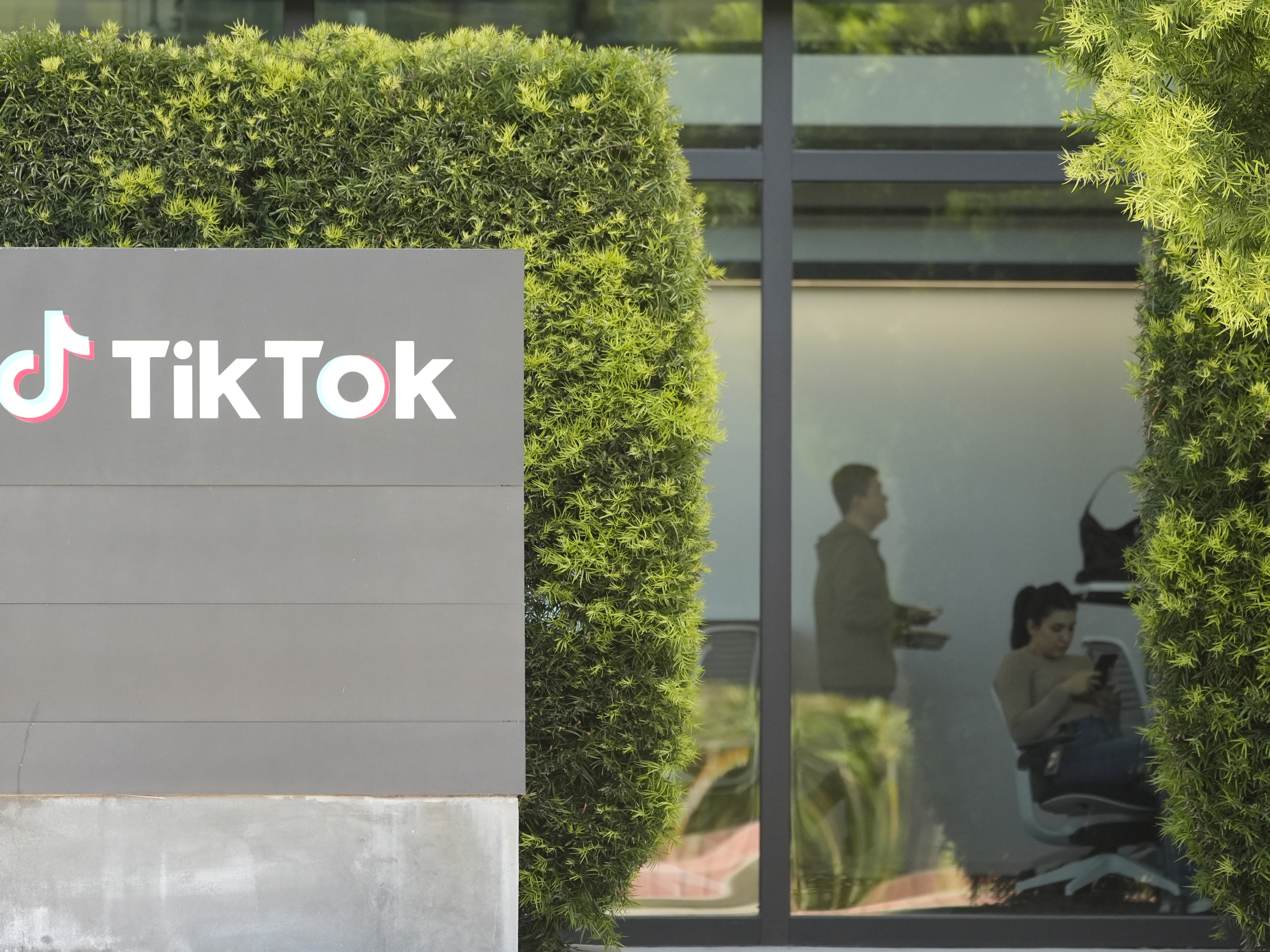 caption: People work inside the TikTok Inc. building in Culver City, Calif., on March 11.