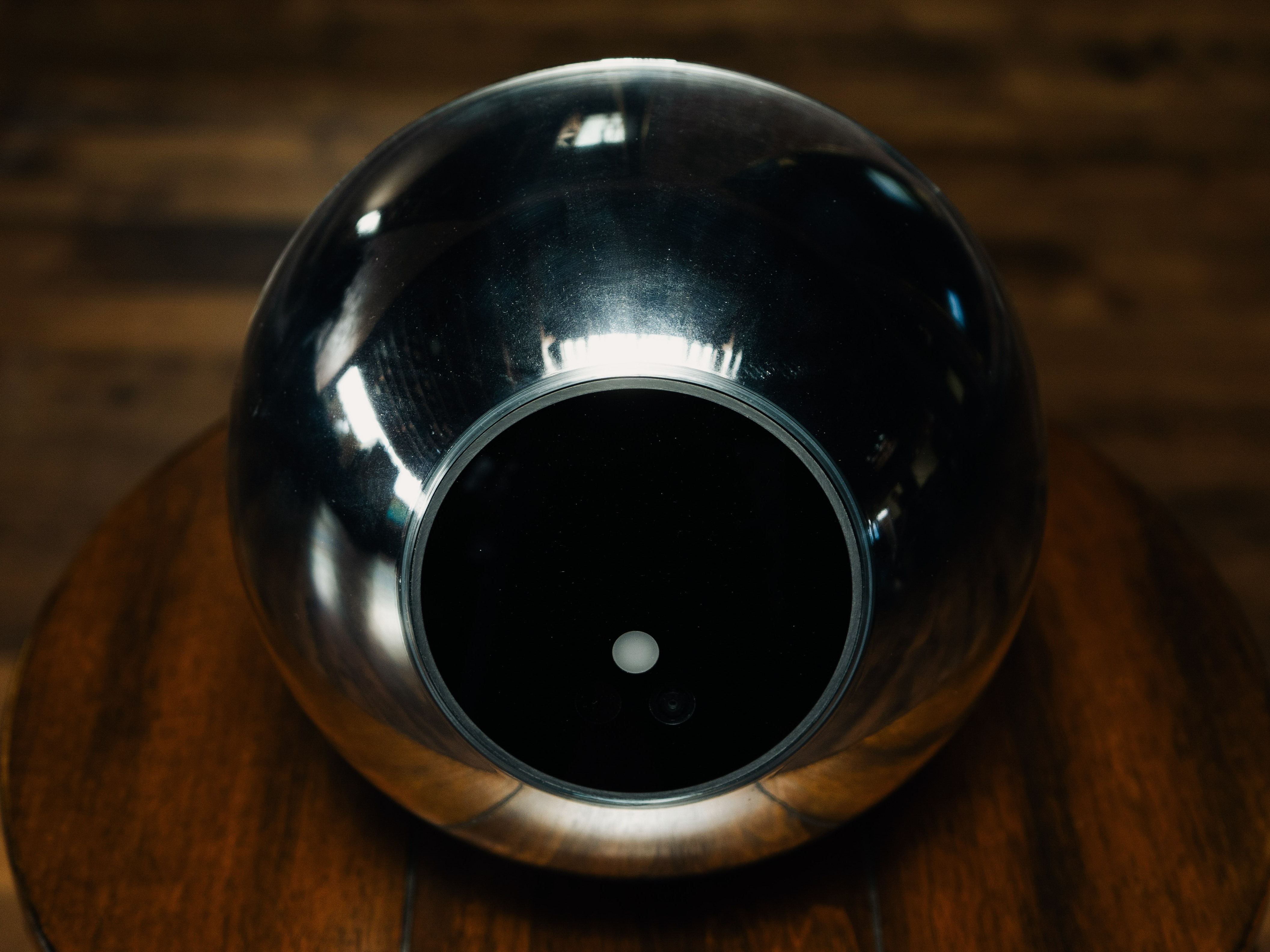 caption: Worldcoin has created a silver orb that scans people's eyeballs in an effort to authenticate every human being in the world.