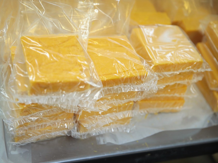 caption: Cheese is packaged for sale at Widmer's Cheese Cellars in 2016 in Theresa, Wis. Record dairy production in the U.S. has produced a record surplus of cheese causing prices to drop.