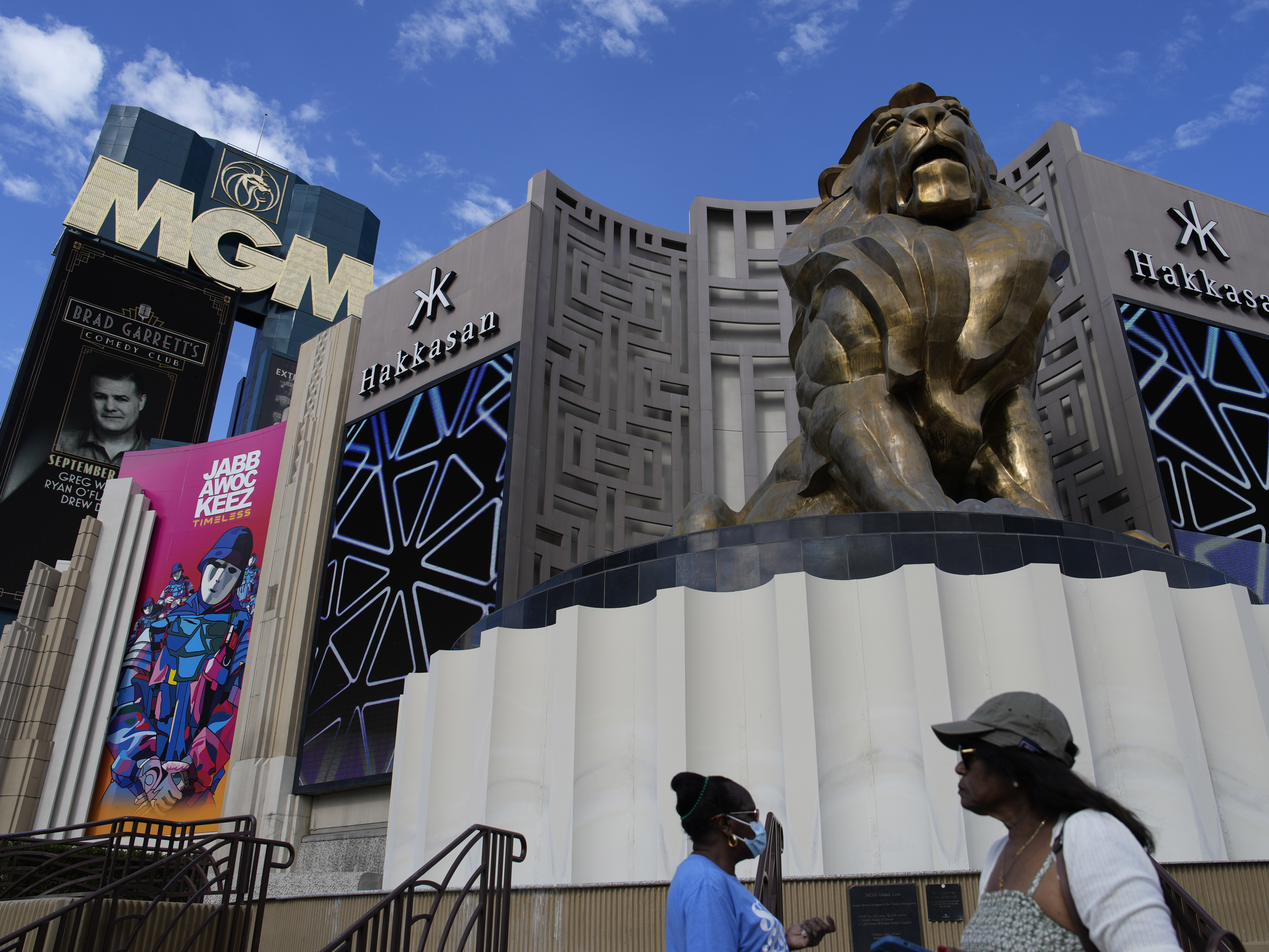 caption: People walk by the MGM Grand hotel-casino in Las Vegas on Wednesday.