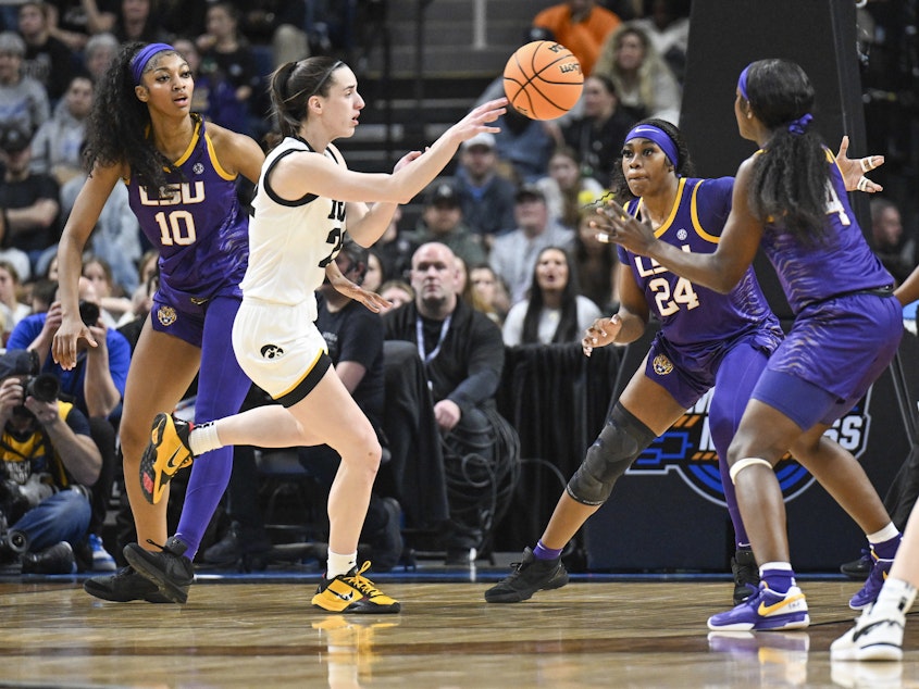 caption: LSU's Angel Reese, left, and Iowa guard Caitlin Clark, center, called their Elite Eight game a great event for their sport. Millions of viewers agreed, launching the contest to the top of ESPN's ratings.