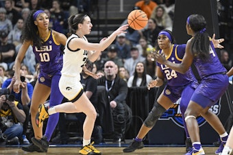 caption: LSU's Angel Reese, left, and Iowa guard Caitlin Clark, center, called their Elite Eight game a great event for their sport. Millions of viewers agreed, launching the contest to the top of ESPN's ratings.