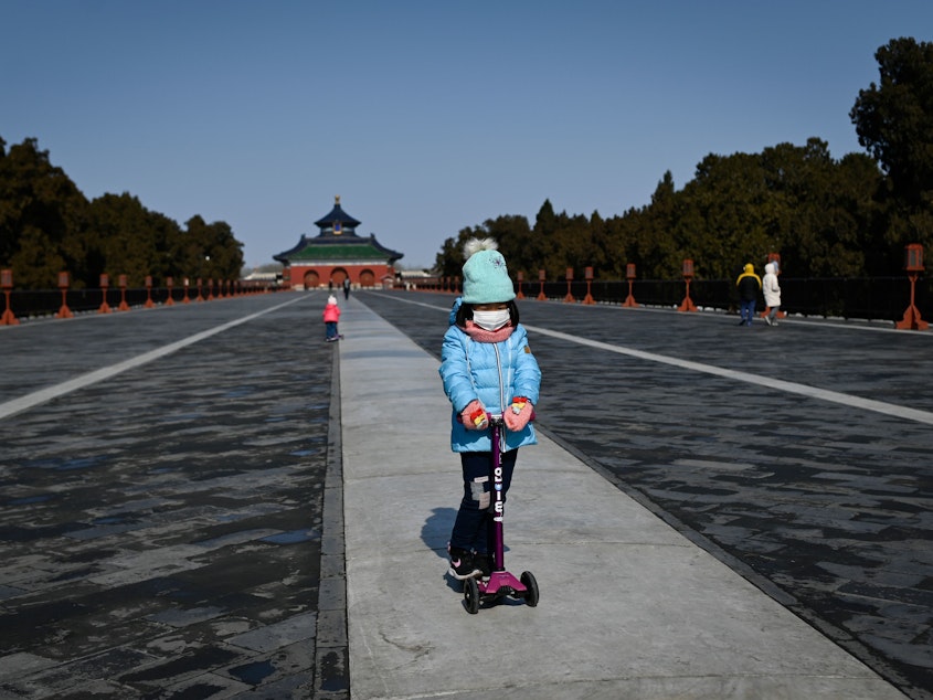 caption: A girl in a park in Beijing on Feb, 15. Researchers are looking at the impact of the newly identified coronavirus on children.