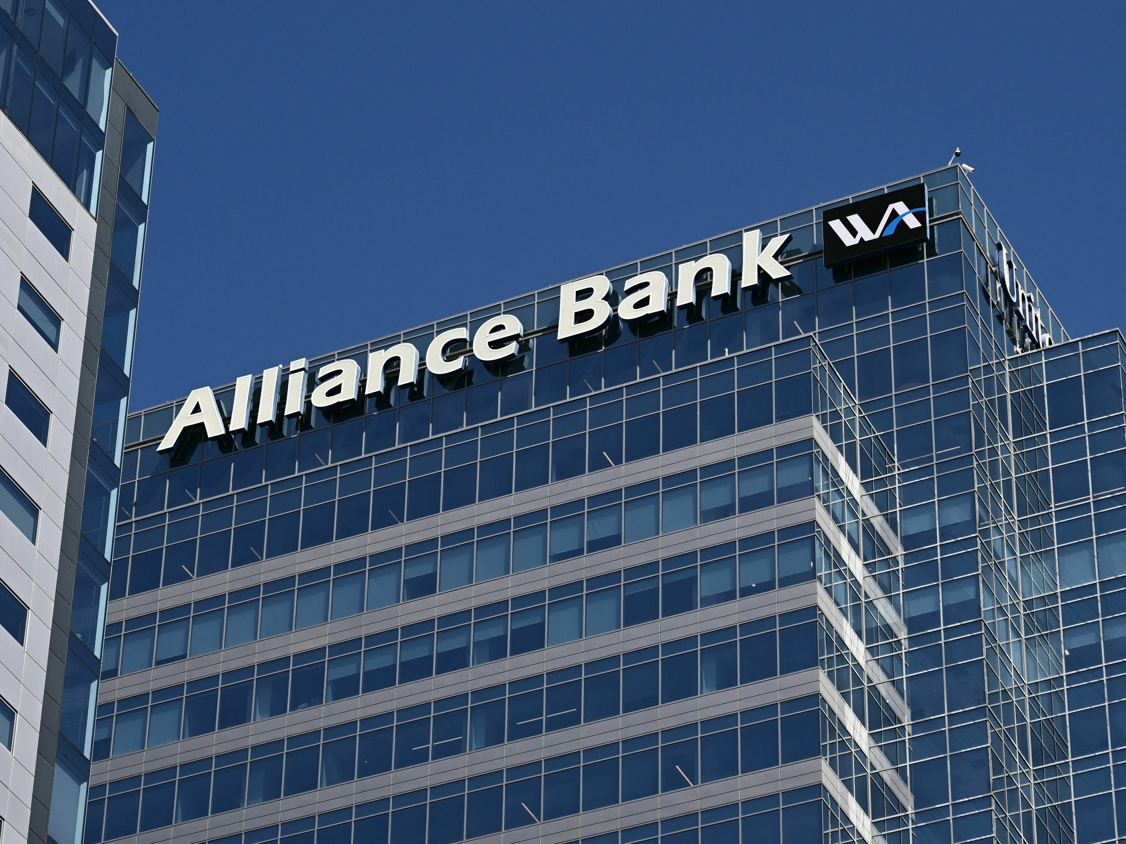 caption: Signage for Western Alliance Bank is displayed at its headquarters in downtown Phoenix on April 27, 2023. - Shares in smaller lenders such as Western Alliance and PacWest are sinking, reviving fears about the banking sector.