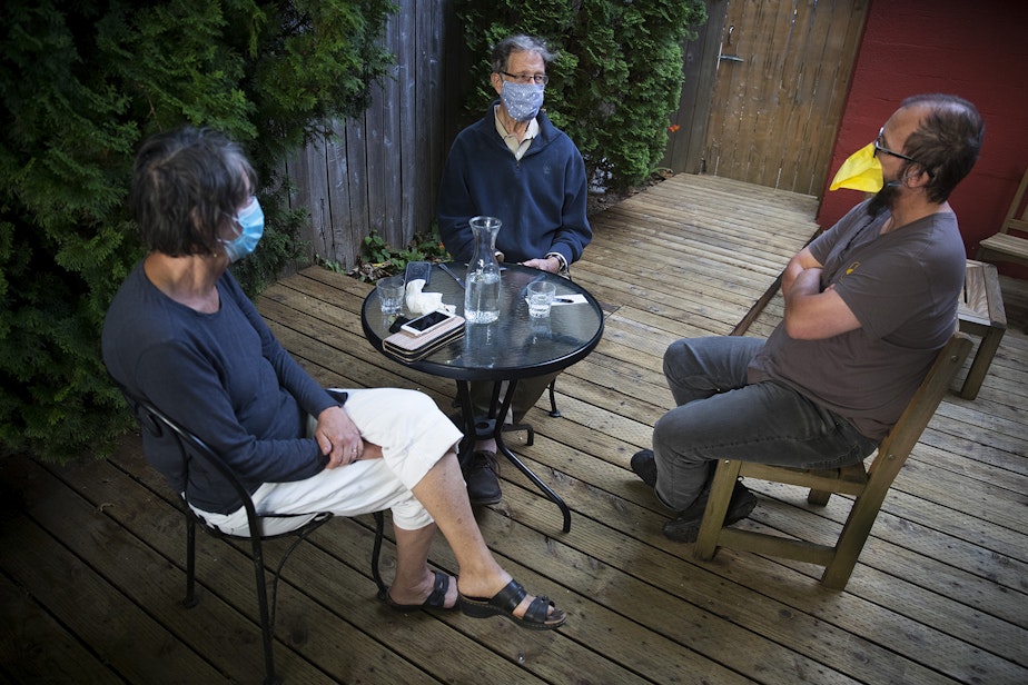 caption: Co-owner of Tippe and Drague Alehouse, Robert McConaughy, right, sits with his cousin, Nick McConaughy, center, and Alberta Conrad, left, on the back patio on Friday, July 24, 2020, in Seattle.