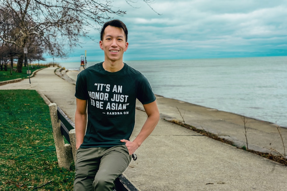 caption: Simon Tran sits for a portrait in Chicago, March 2021. 