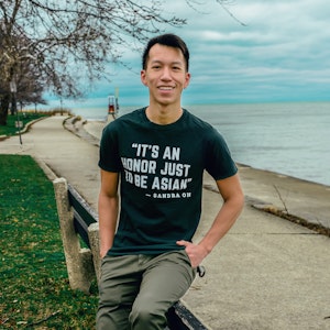 caption: Simon Tran sits for a portrait in Chicago, March 2021. 