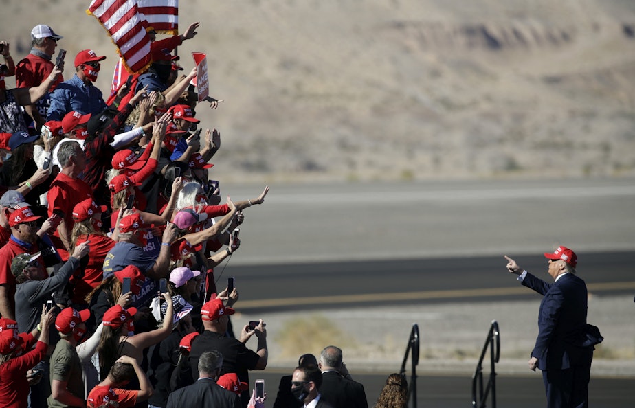 caption: President Donald Trump gestures to supporters following a campaign rally on October 28, 2020 in Bullhead City, Arizona. With less than a week until Election Day, Trump and Democratic presidential nominee Joe Biden are campaigning across the country. (Isaac Brekken/Getty Images)