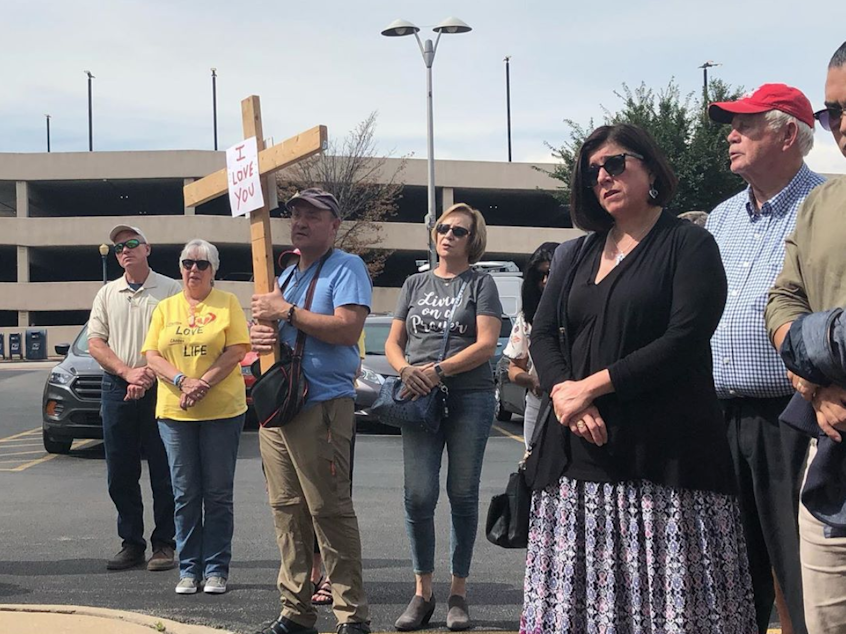 caption: A few dozen anti-abortion activists gathered outside the coroner's office in Will County, Ill., on Thursday, to pray and call for formal burial of the remains.