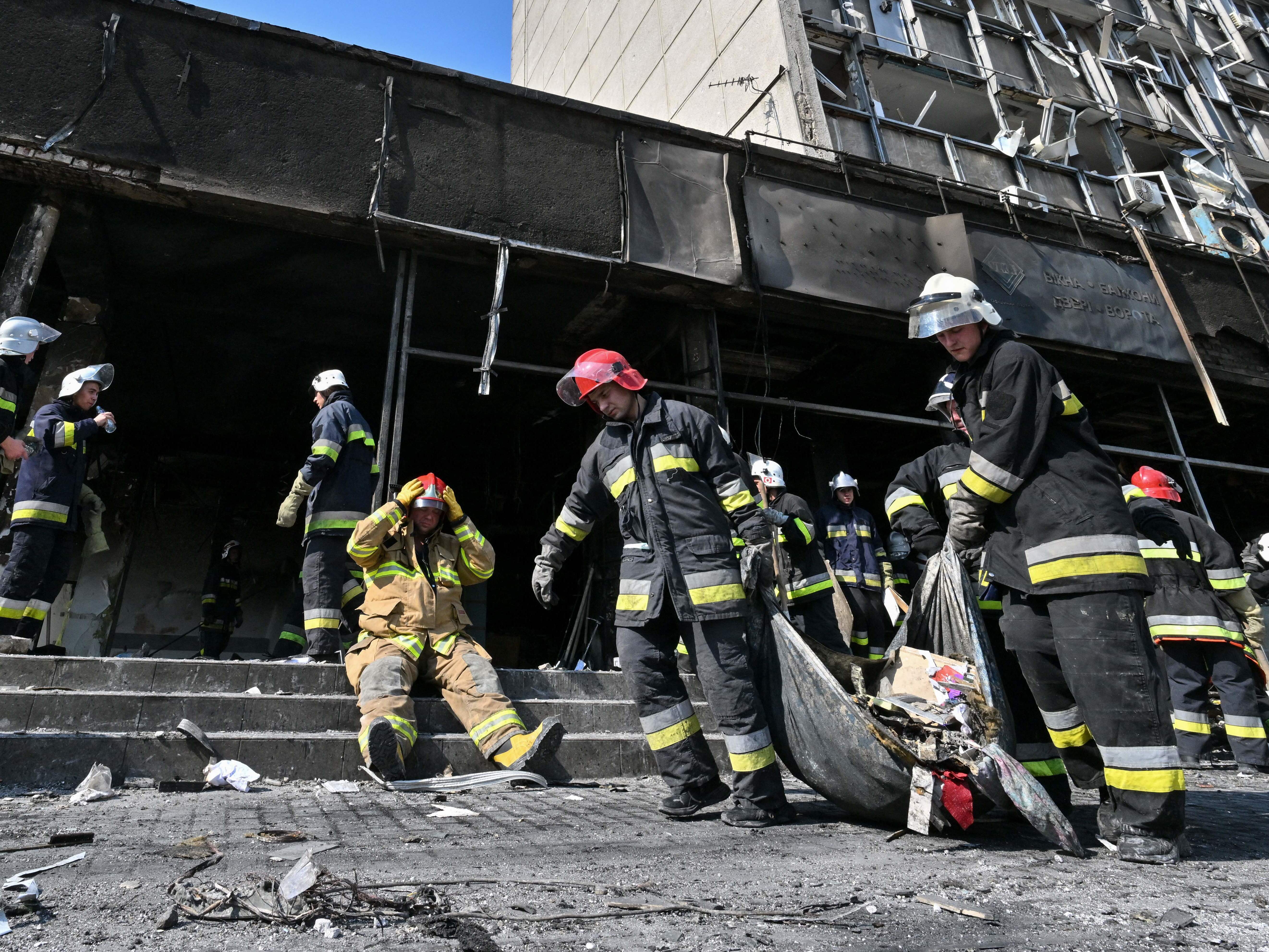 caption: Firefighters remove rubble following a Russian airstrike in the central city of Vinnytsia on Thursday that Ukrainian officials said killed more than 20 people and injured dozens more.