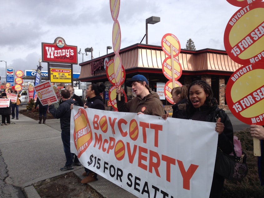 caption: McPoverty protesters outside Wendy's restaurant on Lake City Way in Seattle on Thursday, Feb. 20.