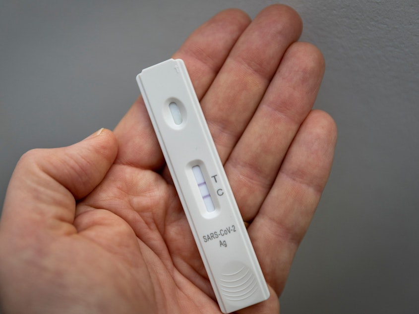 caption: A rapid antigen test shows a positive test result for COVID-19.