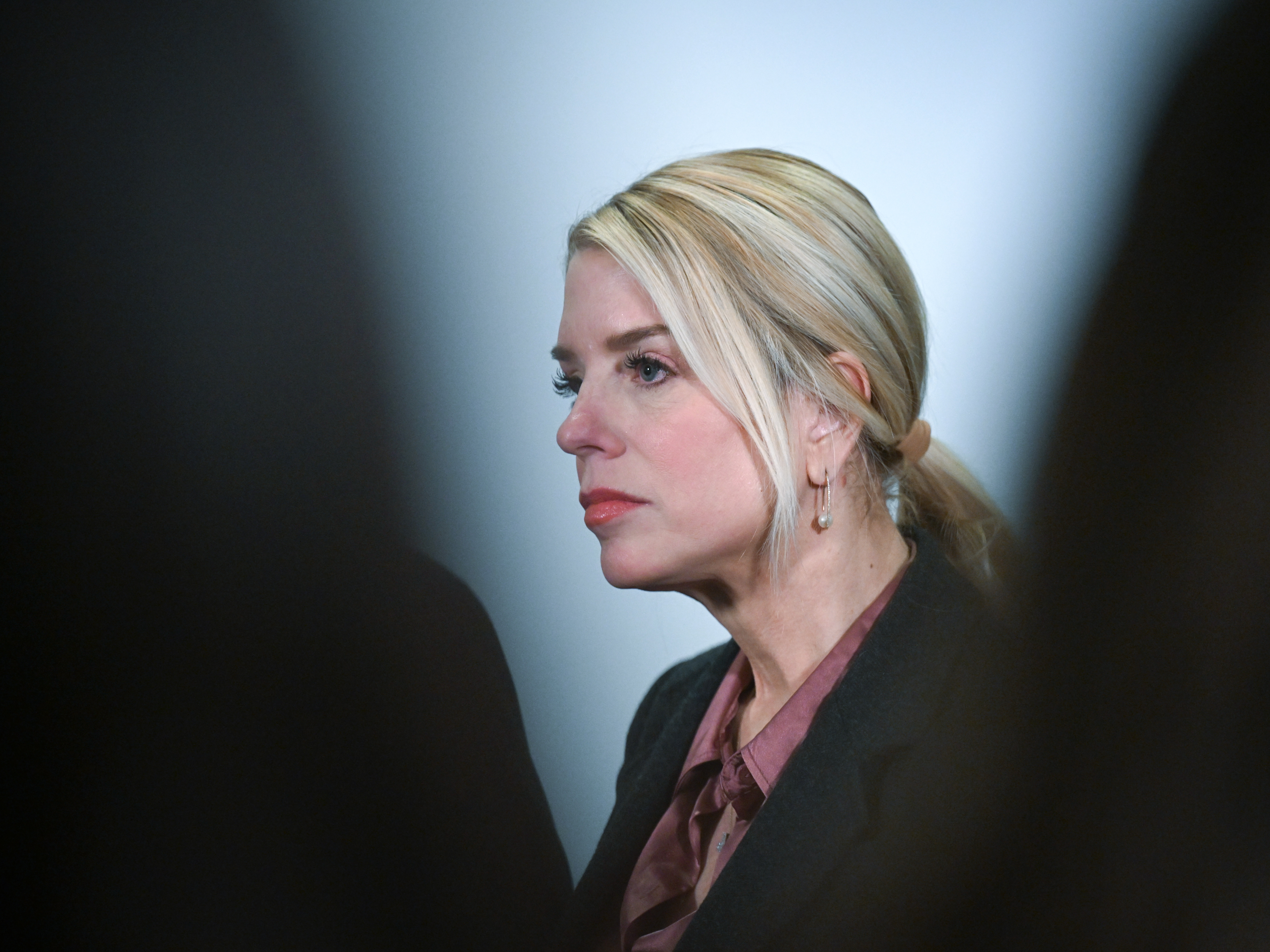 caption: Then-Attorney General Pam Bondi answers questions from the media at the U.S. Capitol on March 18, 2026. Bondi is one of several DOJ officials who've faced ethics complaints with state bar associations in recent years.