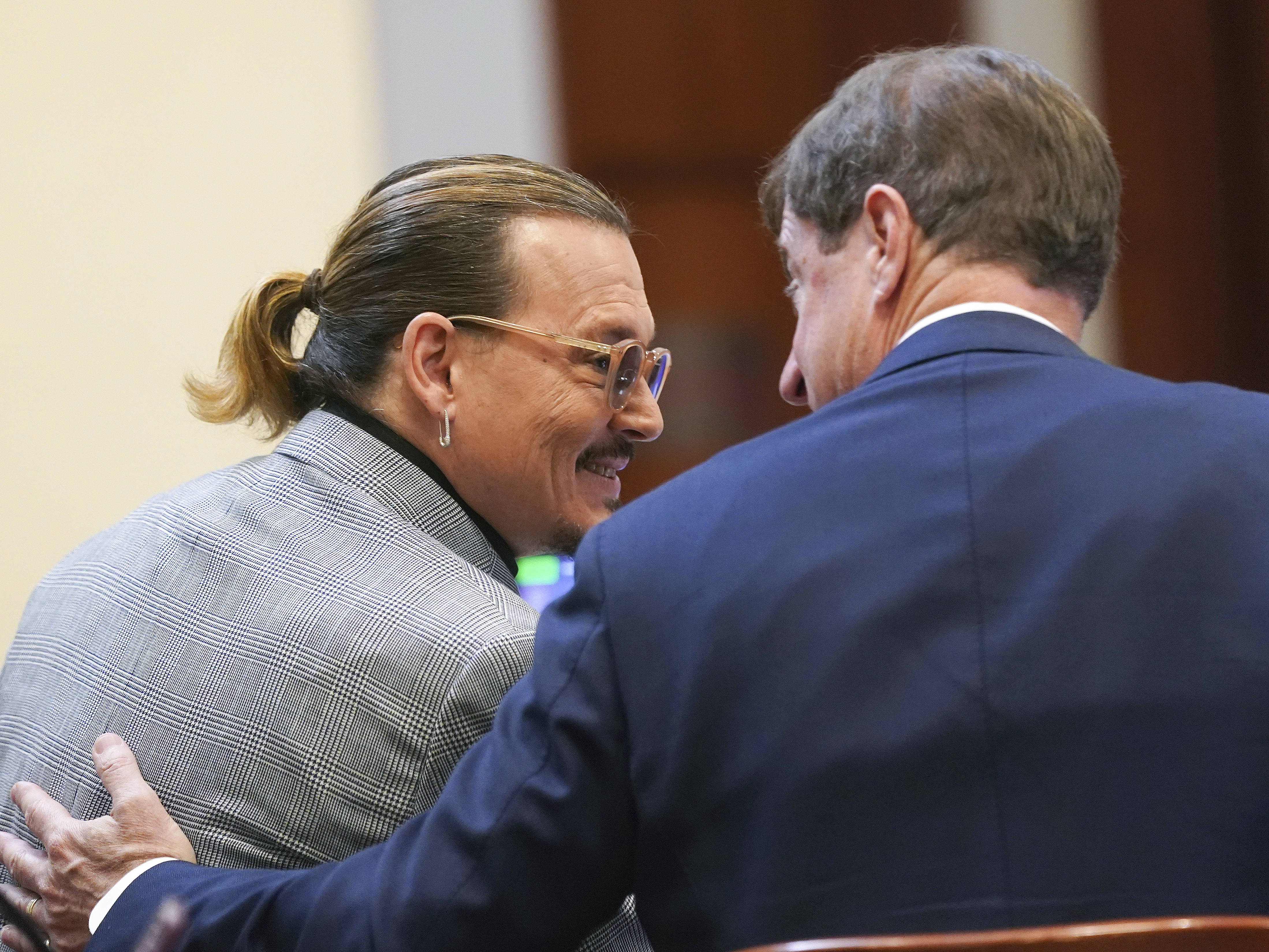 caption: Actor Johnny Depp speaks with his legal team in the courtroom at Fairfax County Circuit Court in Fairfax, Va. on Thursday.
