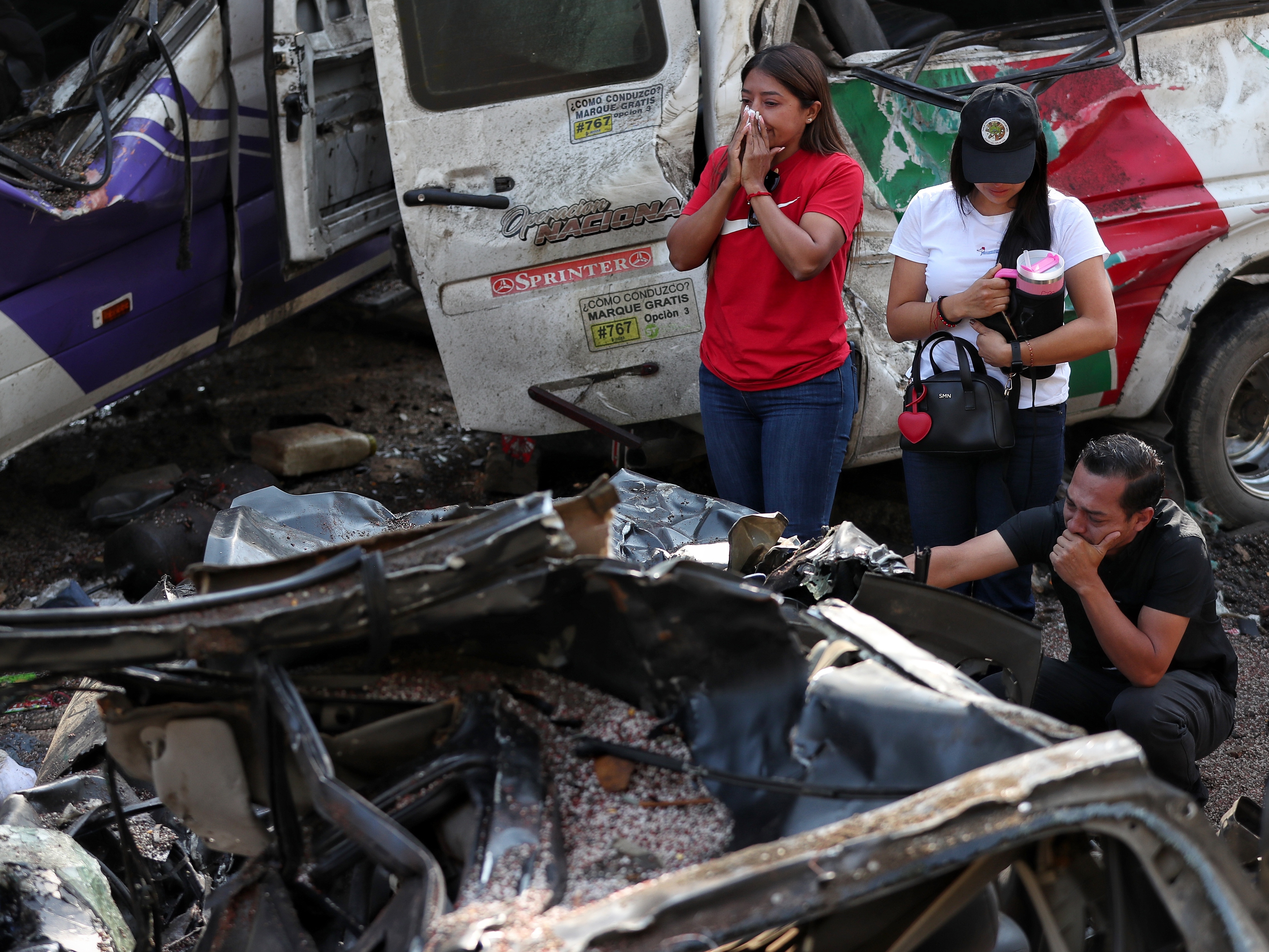 caption: Relatives of victims pay respects at the site of an attack on the Pan-American Highway in Cajibio, Colombia, Sunday, April 26, 2026, where at least a dozen people were killed in an attack authorities blamed on dissident groups of the former FARC rebels.
