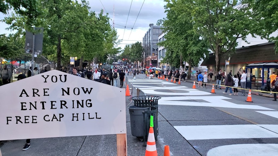 caption: "You are now entering Free Cap Hill," proclaims a sign outside of the so-called Capitol Hill Autonomous Zone.