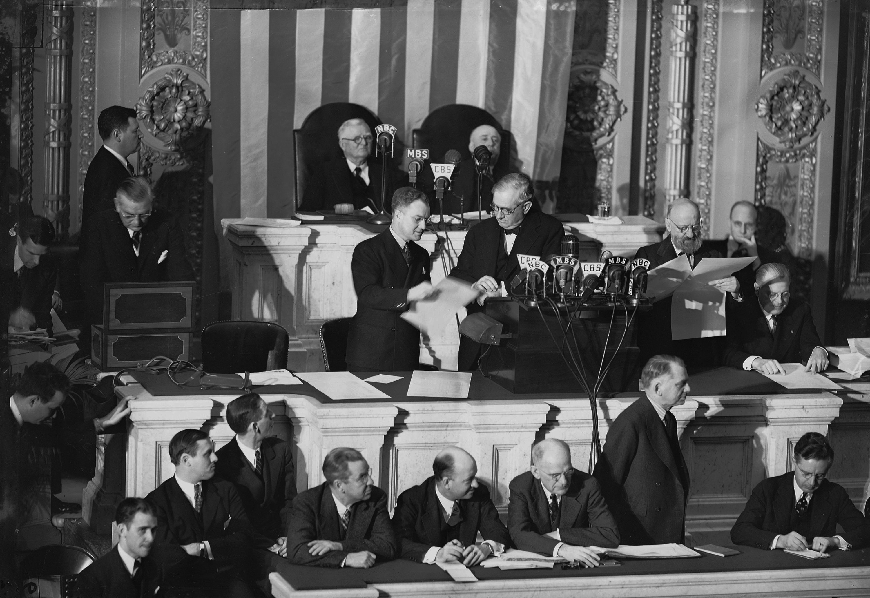 caption: Col. Edwin A. Halsey, far left, secretary of the Senate, takes electoral ballots out of a box as a clerk , center hands them to Sen. Tom Connally, D-Texas, as a joint session counts electoral votes for the November presidential election at the Capitol in Washington, D.C., Jan. 6, 1941. (AP Photo)