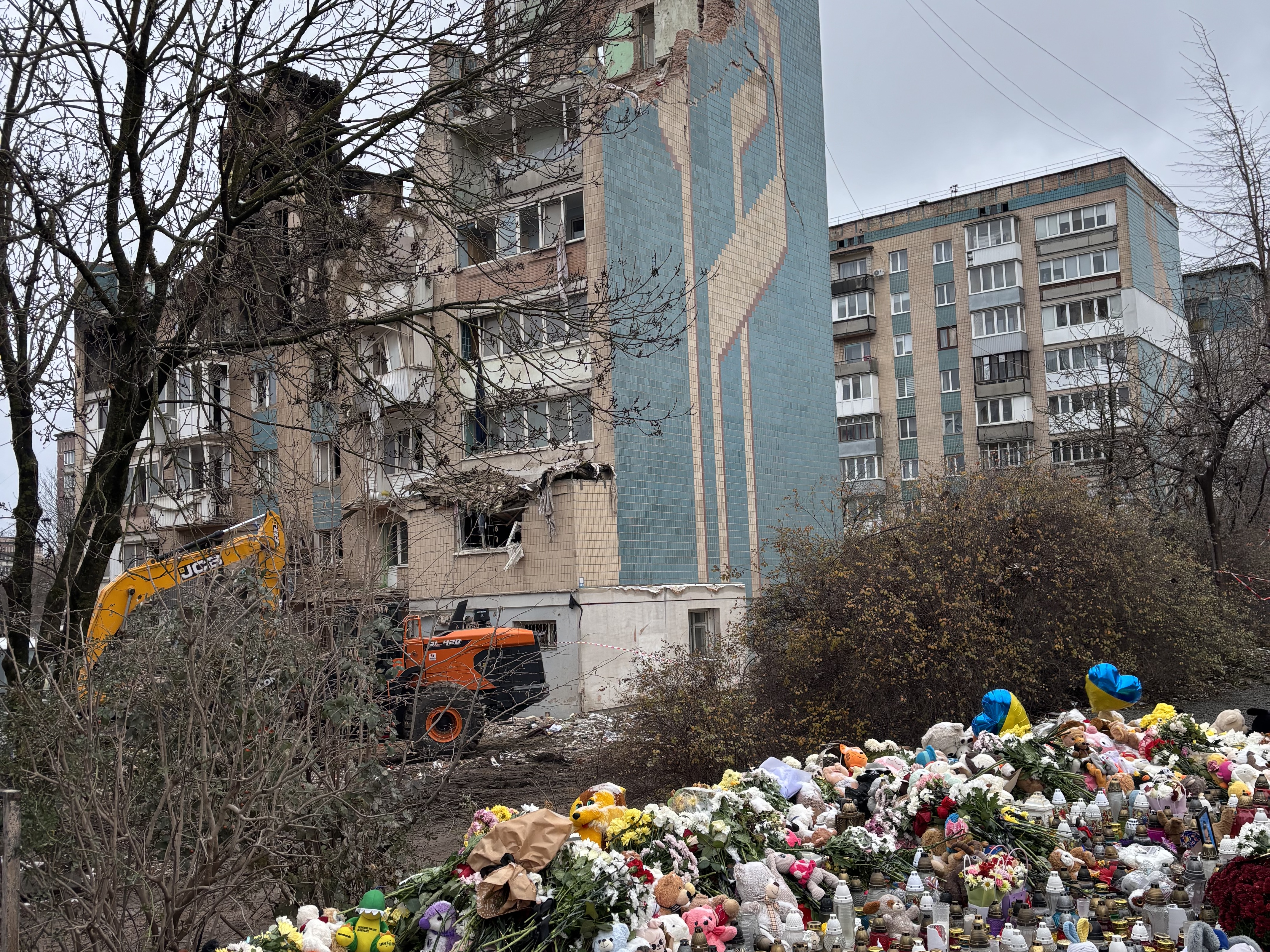caption: Outside a destroyed apartment building in the western Ukrainian city of Ternopil, local residents have left flowers, candles and stuffed toys to commemorate the dozens, including several children, killed in an overnight Russian missile attack