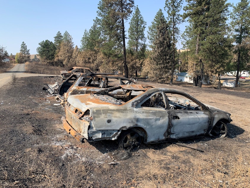 caption: Burned cars from a wildfire that destroyed most of the eastern Washington town of Malden on Labor Day, 2020.