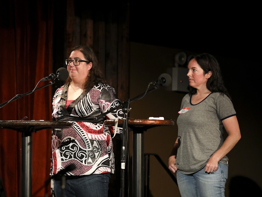 caption: Contestants face off in the final round on Ask Me Another at the Bell House in Brooklyn, New York.