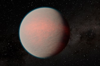 caption: This artist's impression shows a hazy sub-Neptune-sized planet recently observed with the James Webb Space Telescope.