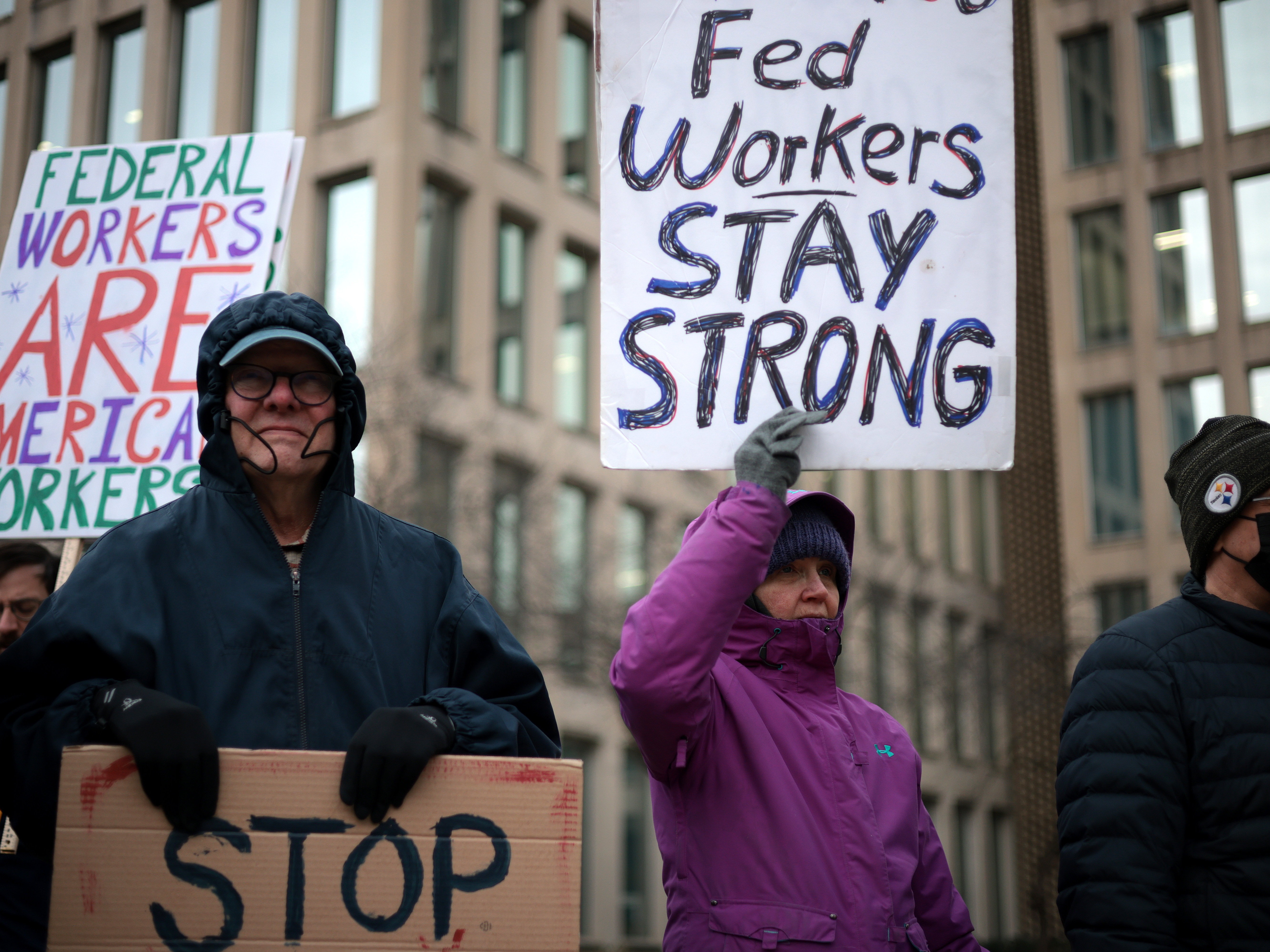 caption: Protesters rally outside of the Theodore Roosevelt Federal Building headquarters of the U.S. Office of Personnel Management on Feb. 5 in Washington, DC.