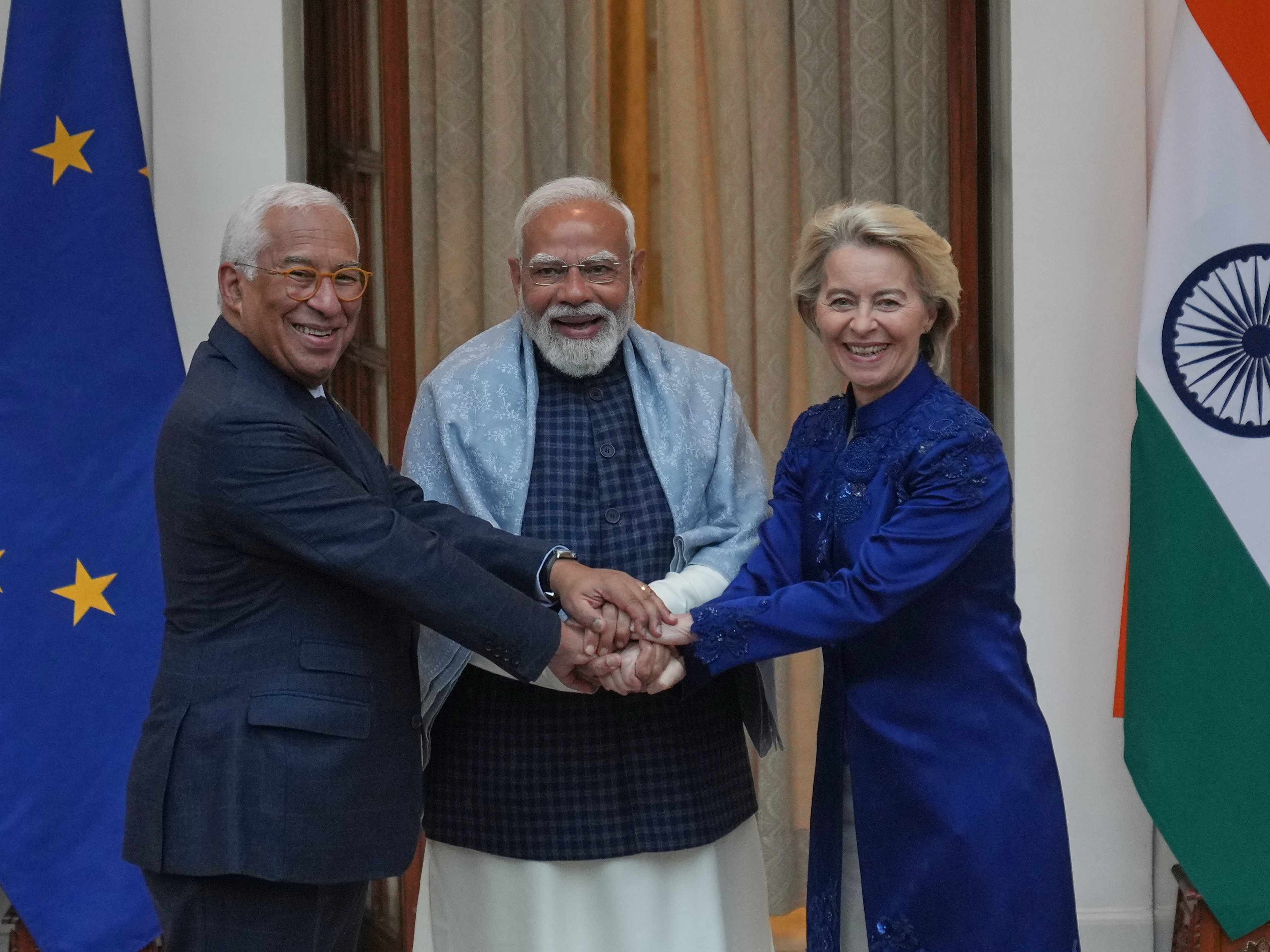 caption: Indian Prime Minister Narendra Modi (center) welcomes European Council President Antonio Costa (left) and European Commission President Ursula von der Leyen before their meeting in New Delhi, India, Tuesday.