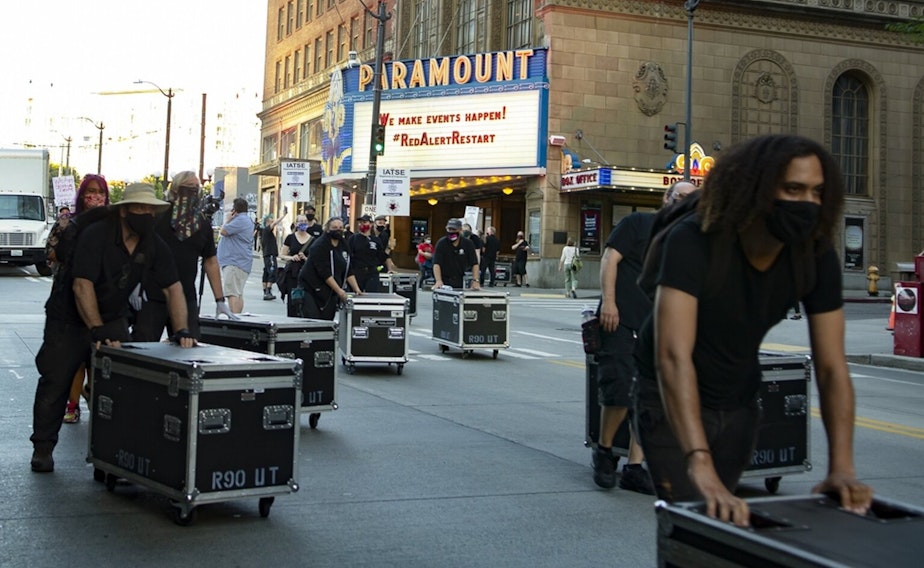 caption: Stagehands in front of the Paramount Theatre