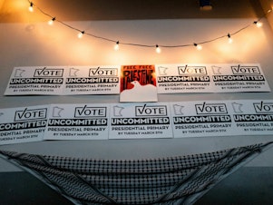 caption: Placards adorn a wall at an Uncommitted Minnesota watch party during the presidential primary in Minneapolis on Super Tuesday.