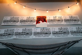 caption: Placards adorn a wall at an Uncommitted Minnesota watch party during the presidential primary in Minneapolis on Super Tuesday.