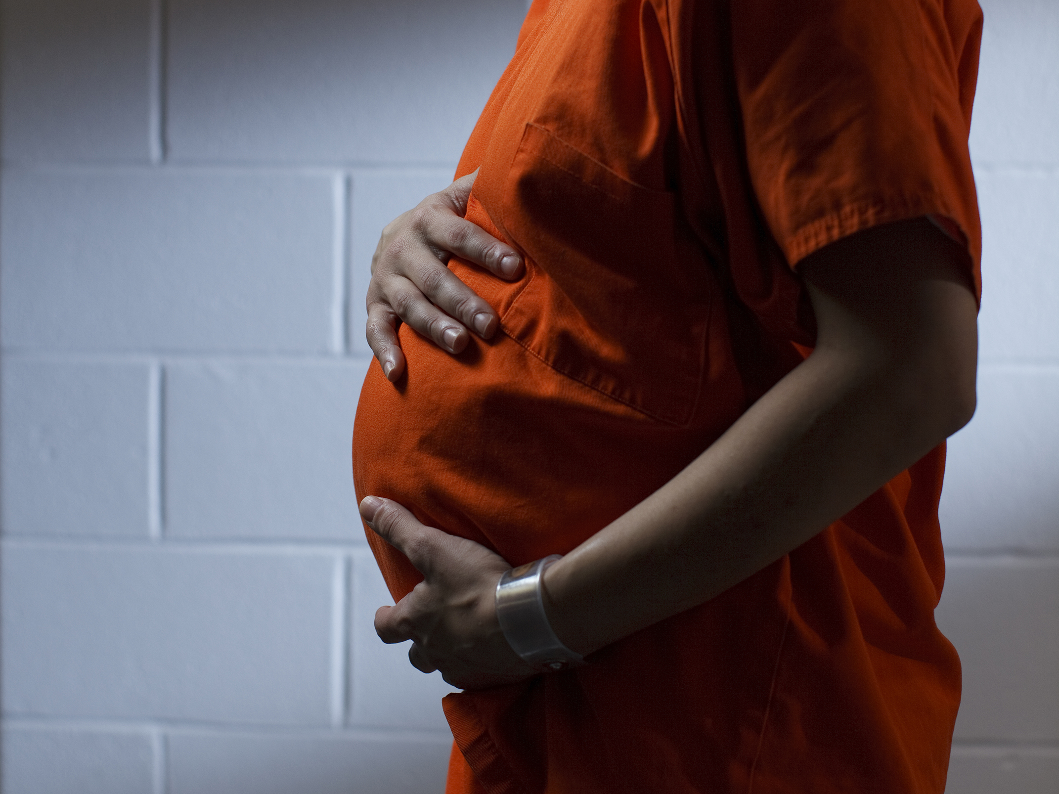 caption: A pregnant female inmate at the Western Massachusetts Regional Women's Correctional Center in Chicopee, Mass., poses for a portrait in the facility's visiting area in 2014.