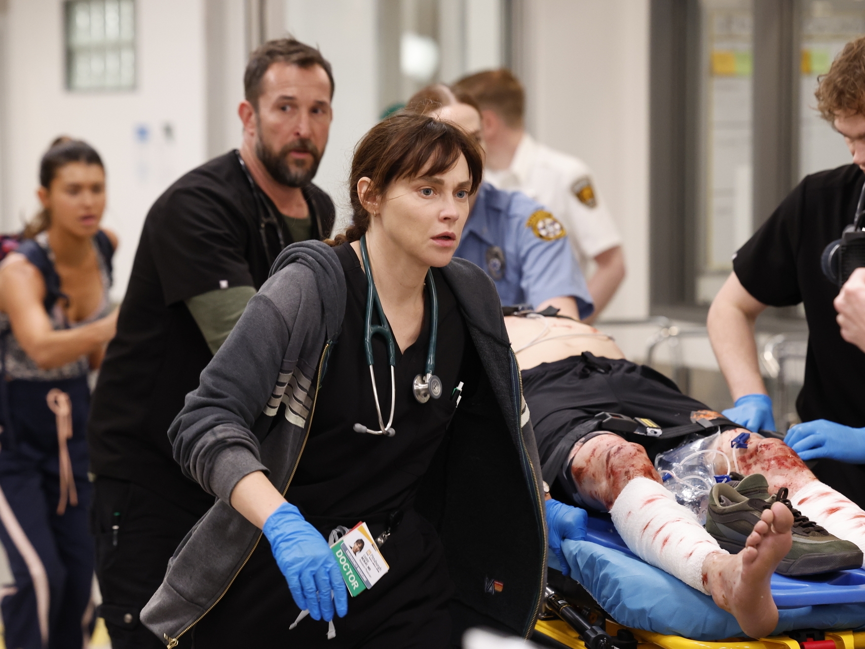 caption: From left: Noah Wyle plays Dr. Michael "Robby" Robinavitch, the senior attending physician, and Fiona Dourif plays Dr. Cassie McKay, a third-year resident, in a fictional Pittsburgh emergency department in the HBO Max series <em>The Pitt</em>.
