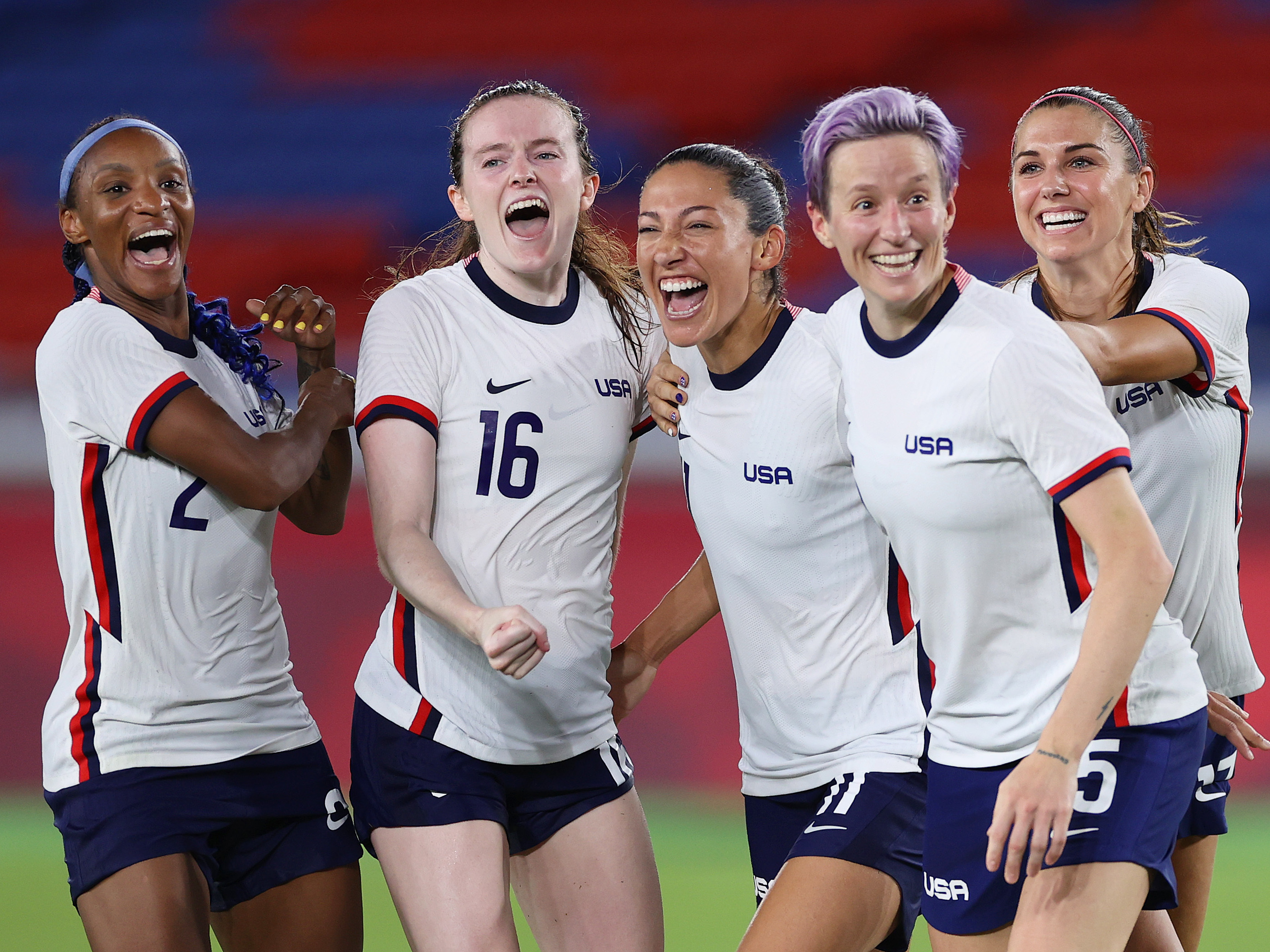 caption: Players on the U.S Women's National Team celebrate their victory in the penalty shootout over the Netherlands in the Women's Quarter Final match of the Tokyo 2020 Olympics.