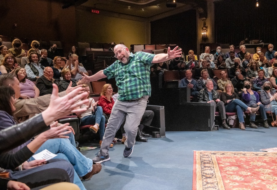 caption: Ian Bell high-fives the entire room in Every Brilliant Thing, by Duncan Macmillan with Jonny Donahoe and directed by John Langs, onstage March 23-April 2, 2023 at ACT—A Contemporary Theatre. 