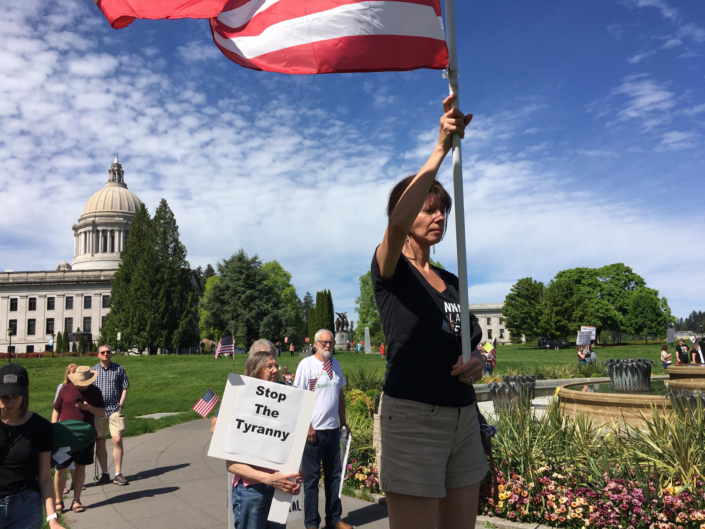 caption: Participants at the Saturday rally prayed as the event got underway. Government overreach and tyranny were common themes.