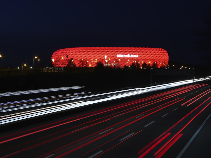 caption: In a photo from March of last year, cars pass the illuminated Allianz Arena soccer stadium in Munich, Germany. UEFA has nixed plans for the stadium to light up in rainbow colors Wednesday to protest a new Hungarian law seen as homophobic.