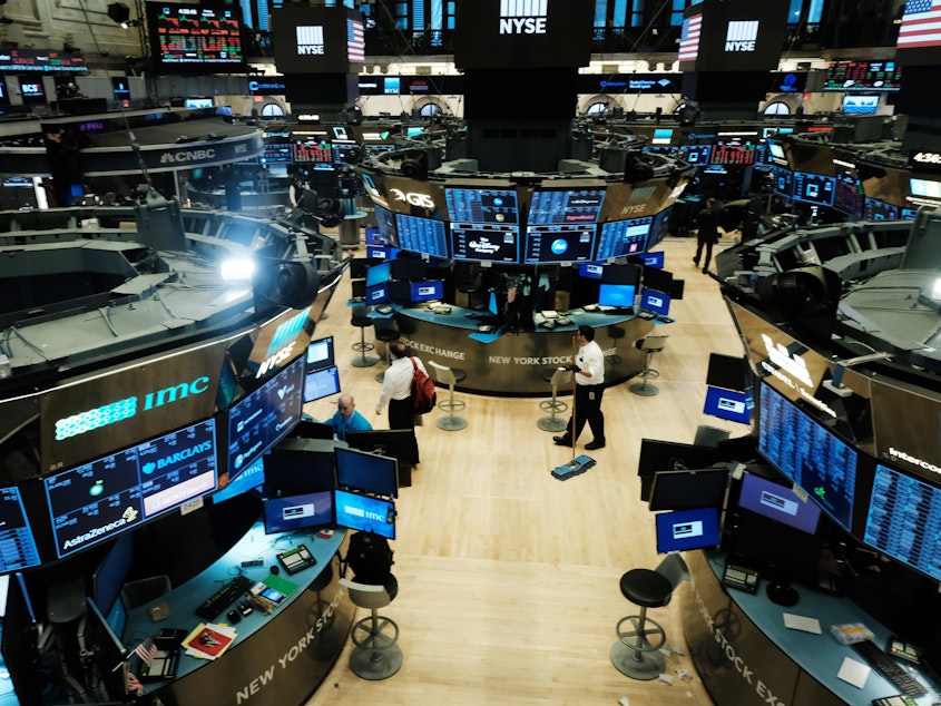 caption: Trading ends for the day on the floor of the New York Stock Exchange on March 20. It was the last day before the exchange switched to all-electronic trading in an effort to help contain the spread of the coronavirus.