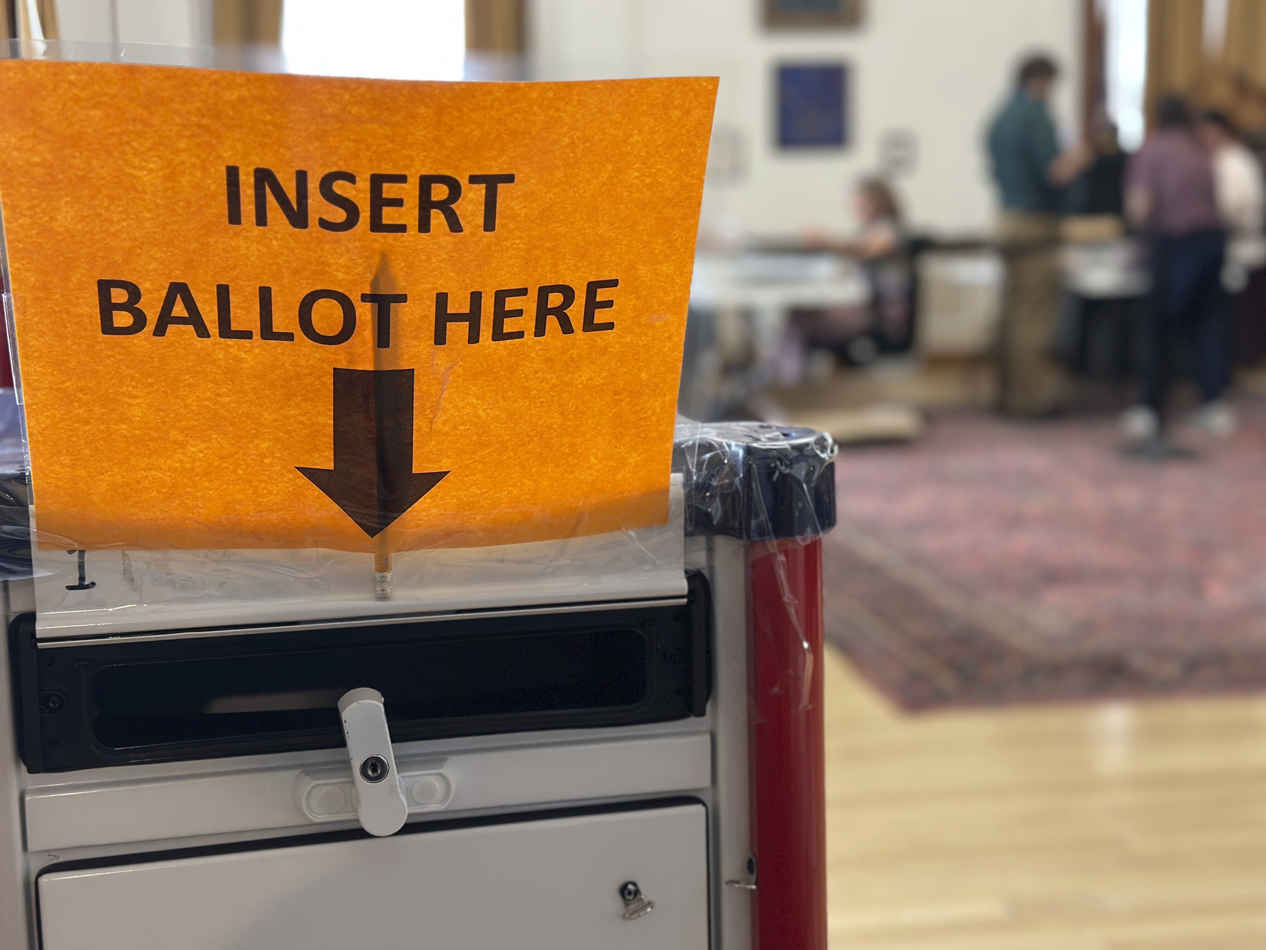 caption: Election workers process absentee ballots on Nov. 4, 2024, in Portland, Maine. Maine is forgoing roughly $130,000 in election security grant money because the state does not plan to comply with new requirements from the Trump administration.