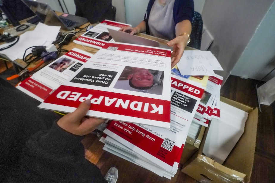 caption: Posters of Israeli hostages being held by Hamas is handed out during a photo shoot for a visual project calling for their release, Wednesday, Nov. 1, 2023, in New York. While the posters were created to raise awareness and support, they've also angered others who are critical of Israel's actions and history in the conflict with Palestinians.