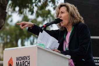 caption: Kirsten Engel, an Arizona Democrat running for U.S. House, speaks during a Women's March rally in Phoenix on Jan. 20.