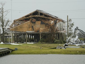 caption: A home damaged by Hurricane Laura is seen in Hackberry, La., Friday. Damage estimates from the storm range from around $4 billion to $12 billion.