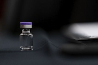 caption: An example of a vial that will carry the COVID-19 vaccine produced by Pfizer and BioNTech sits on display during a Senate subcommittee hearing Thursday.