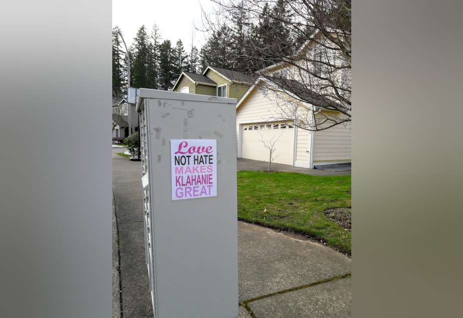 caption: The community response to the racist vandalism has been swift. These, and other signs, are now found all over Klahanie.