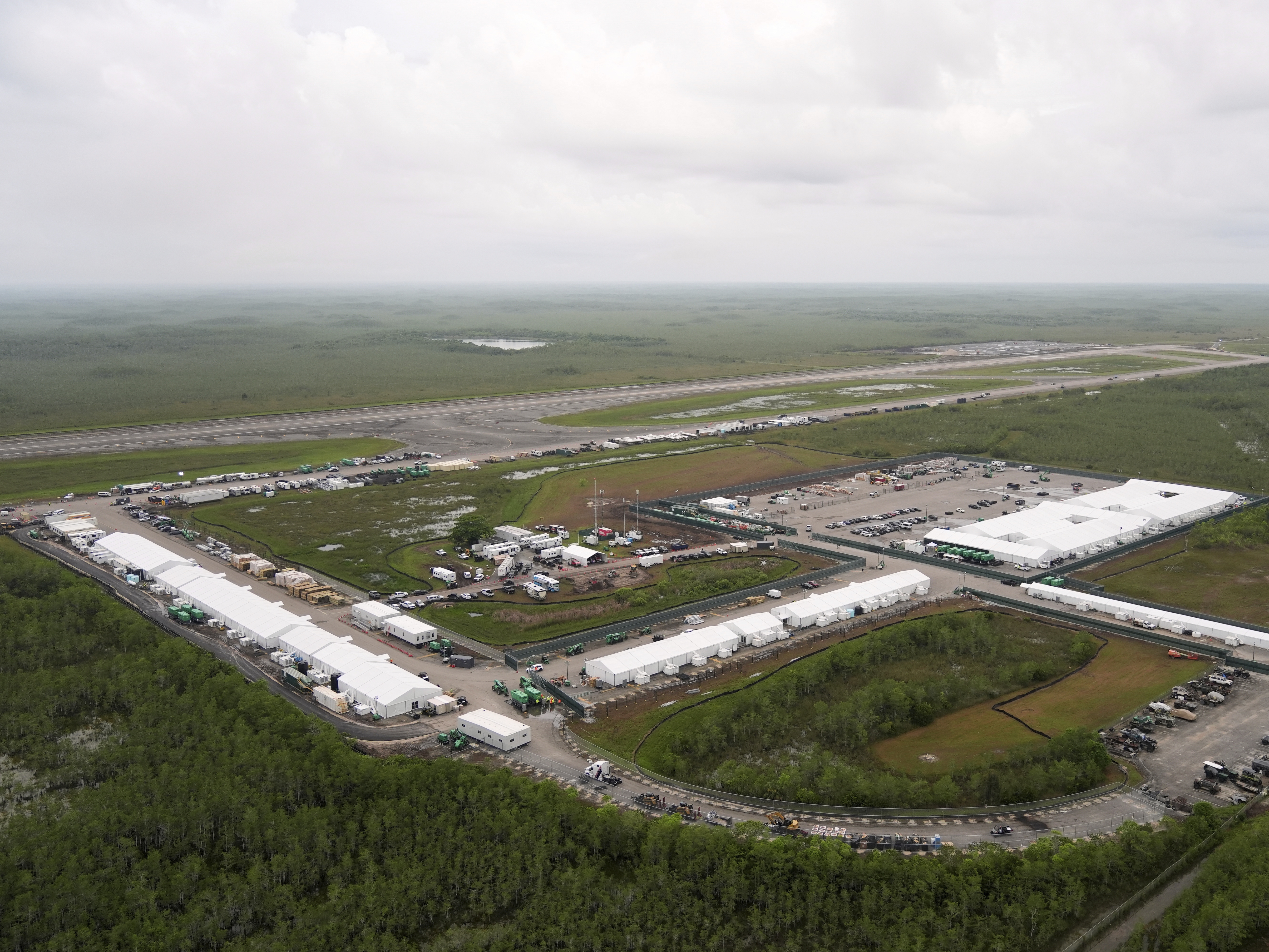 caption: The immigrant detention facility known as "Alligator Alcatraz" is shown on July 4, 2025, as construction was finishing at the Dade-Collier Training and Transition airport in the Florida Everglades. A lawsuit, brought by environmental groups and the Miccosukee tribe, has challenged the expansion and operations of the facility.