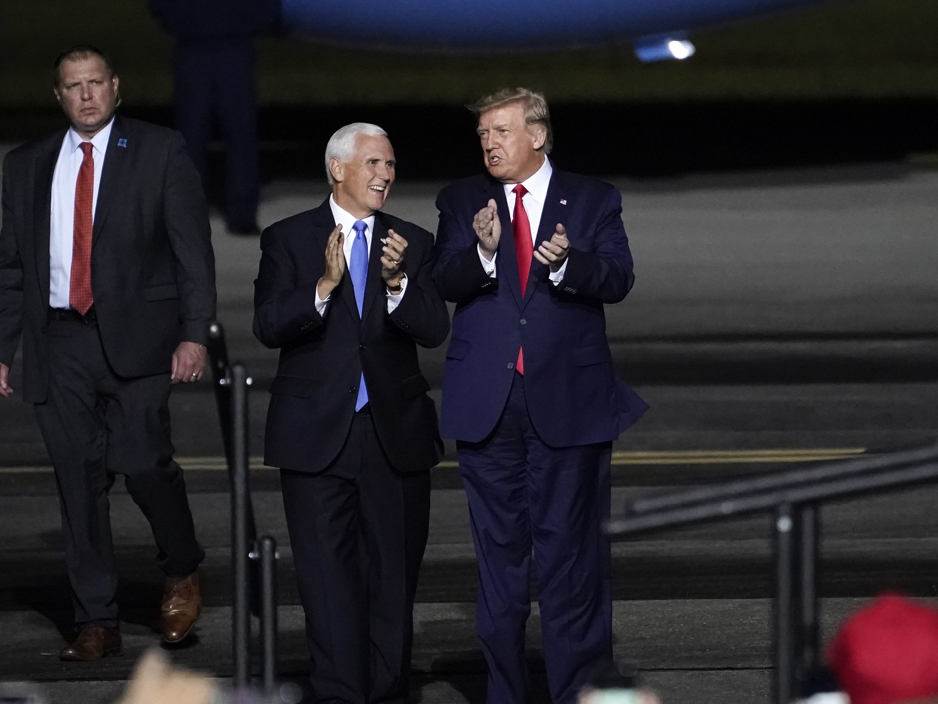 caption: Vice President Mike Pence and President Trump at a campaign rally at Newport News, Va., on Sept. 25, a week before Trump was hospitalized with COVID-19.