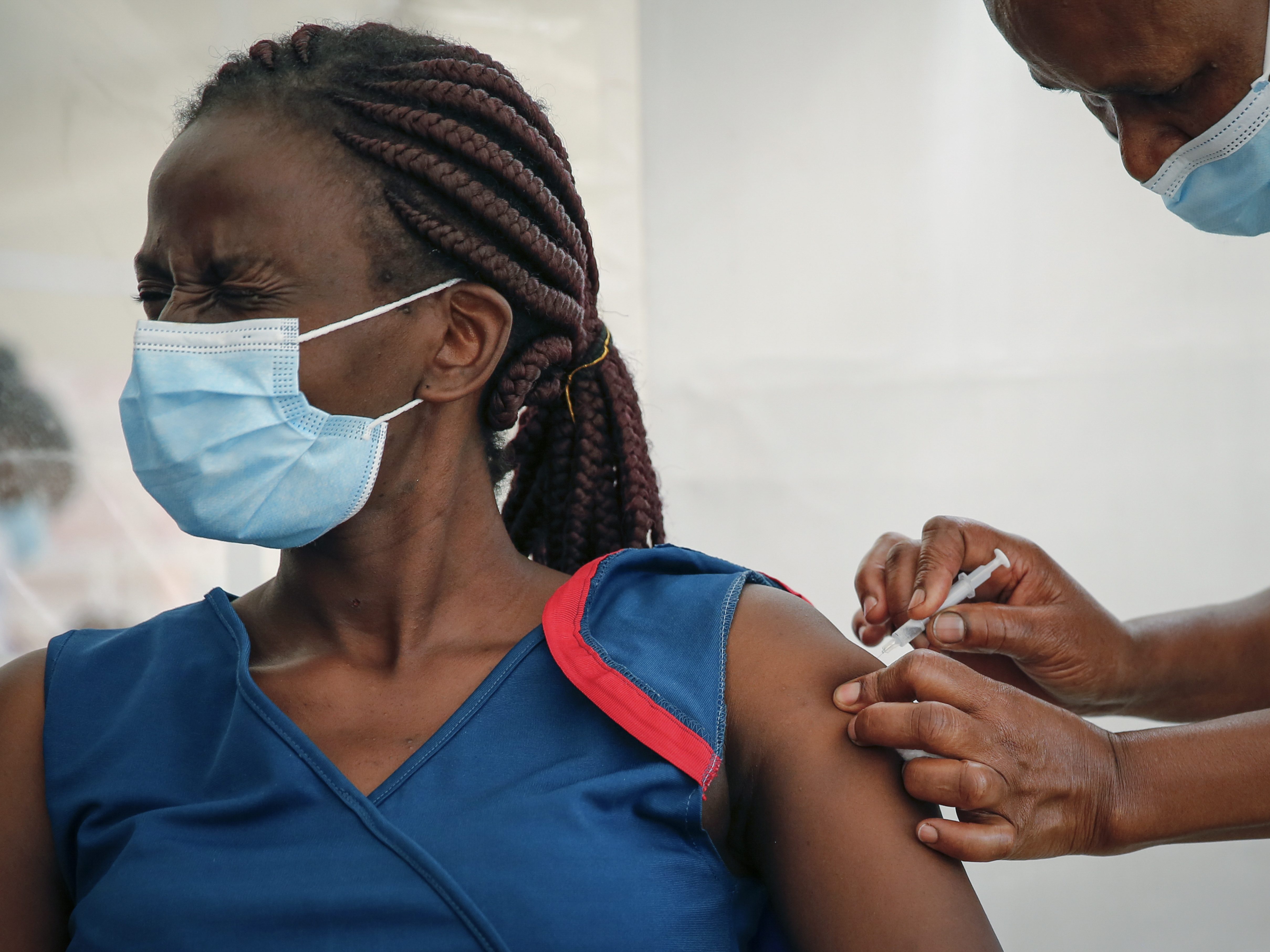 caption: A front-line worker in Kenya receives a shot of the AstraZeneca COVID-19 vaccine. African Families for Holistic Health Organization in Portland, Ore., hopes that the work they do in the U.S. will help curb vaccine misinformation back in Africa.