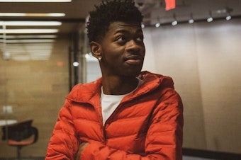 caption: Despite Lil Nas X's viral hit "Old Town Road" having a blend of rap and country elements, <em>Billboard</em> removed the song from its Hot Country Songs chart.