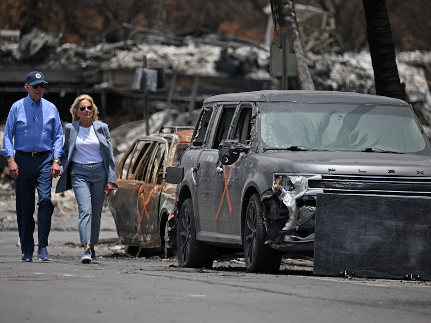 caption: President Biden and first lady Jill Biden view damage caused by wildfires in Lahaina, Hawaii on August 21, 2023. The president is expected to travel to see hurricane damage Florida on Saturday.